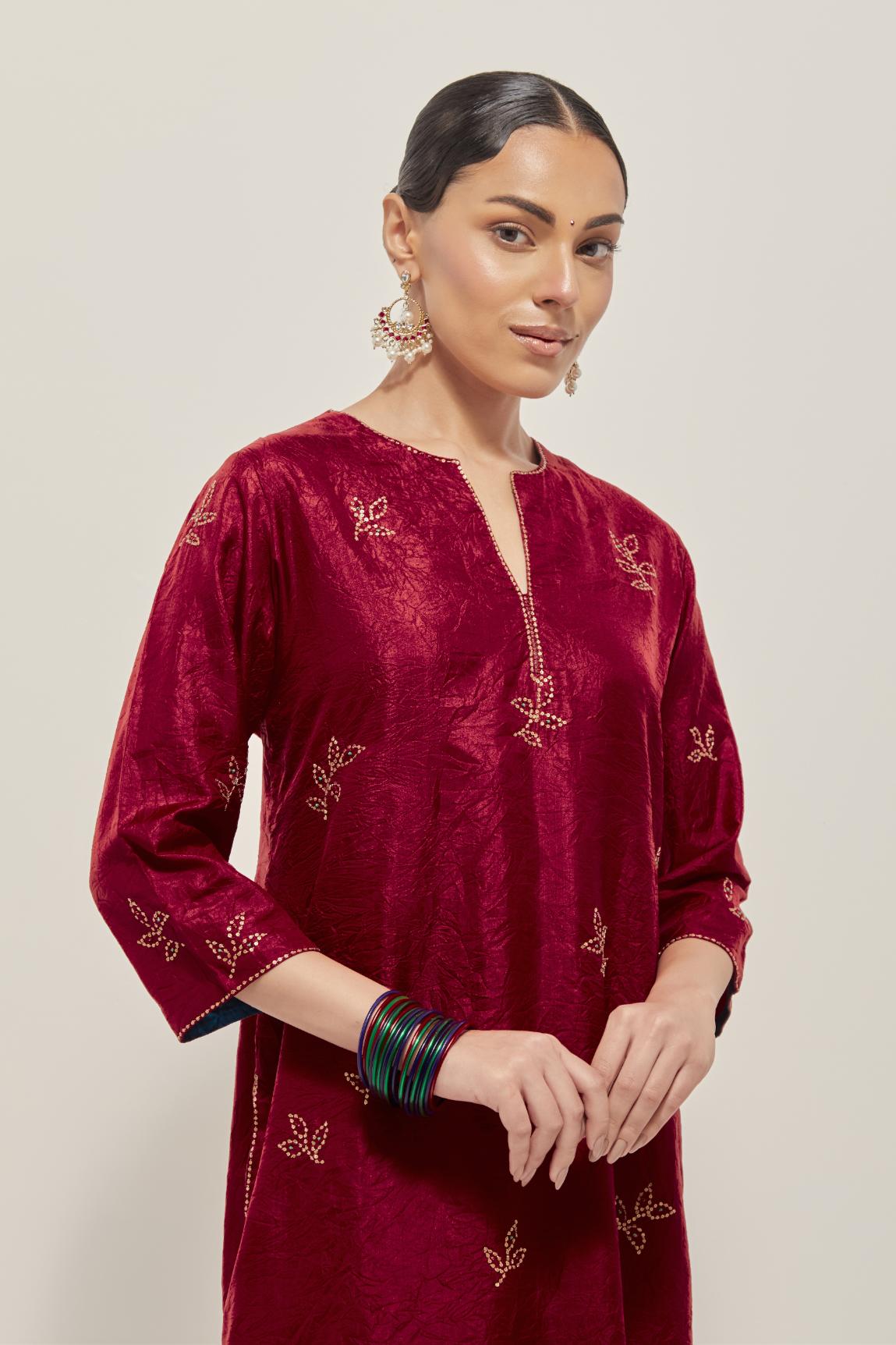 Red Silk kurta set with hand embroidered sequins on bandhani inspired floral motif all-over the kurta, highlighted with contrast-colored beads.