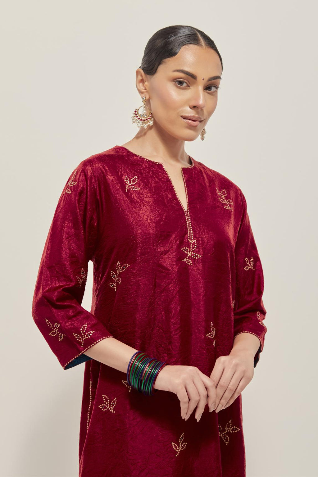 Red Silk kurta set with hand embroidered sequins on bandhani inspired floral motif all-over the kurta, highlighted with contrast-colored beads.