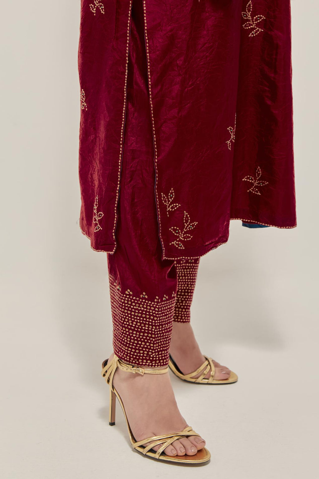 Red Silk kurta set with hand embroidered sequins on bandhani inspired floral motif all-over the kurta, highlighted with contrast-colored beads.