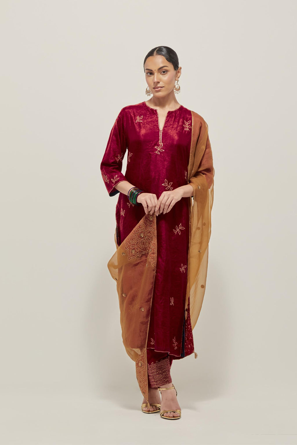 Red Silk kurta set with hand embroidered sequins on bandhani inspired floral motif all-over the kurta, highlighted with contrast-colored beads.
