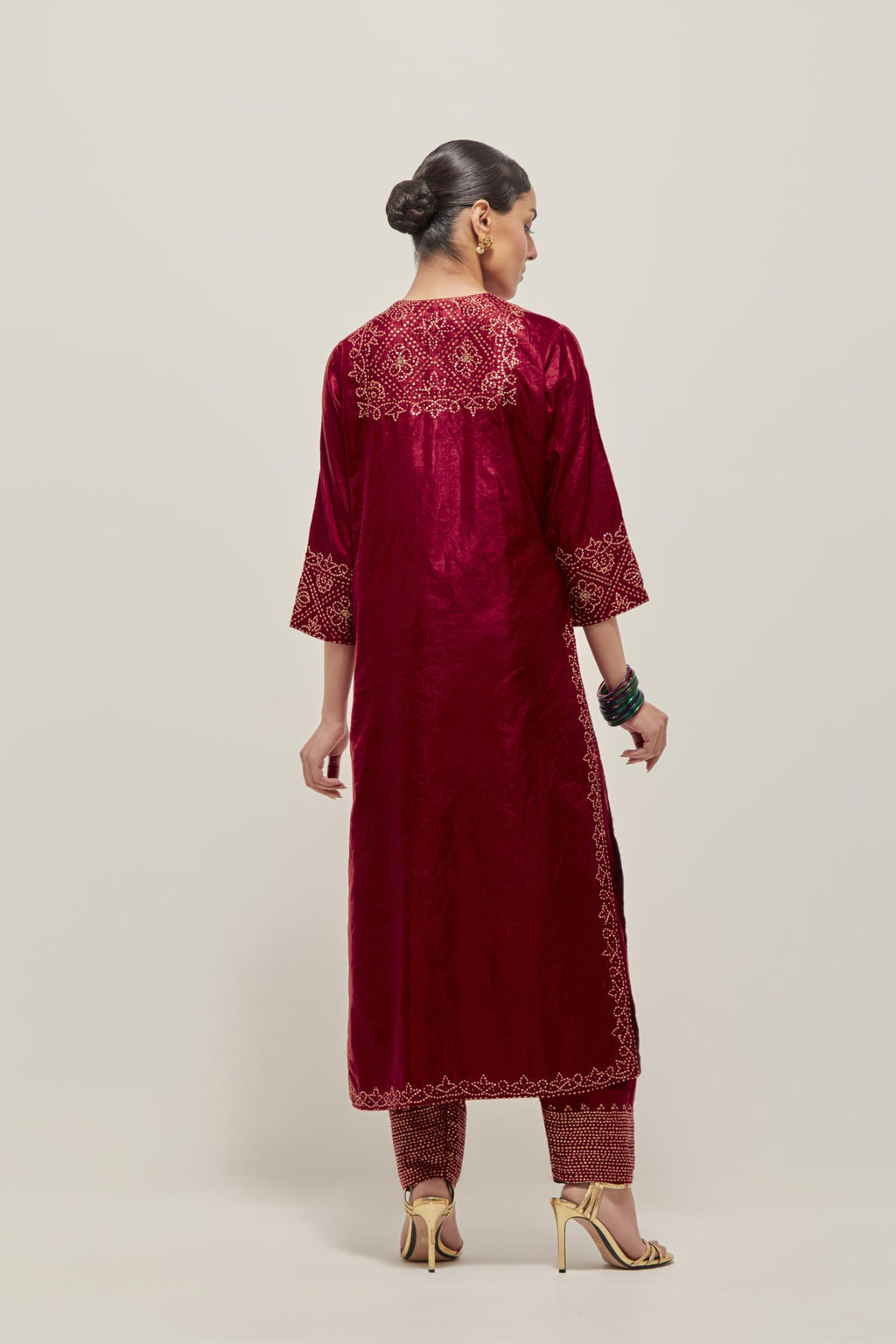 Red Silk kurta set with hand embroidered sequins on bandhani inspired jaal work at neck, hem and sleeves cuff, highlighted with contrast-colored beads.