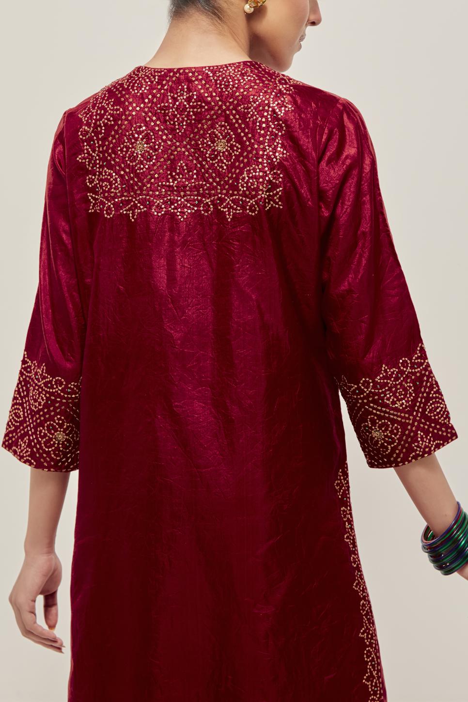 Red Silk kurta set with hand embroidered sequins on bandhani inspired jaal work at neck, hem and sleeves cuff, highlighted with contrast-colored beads.