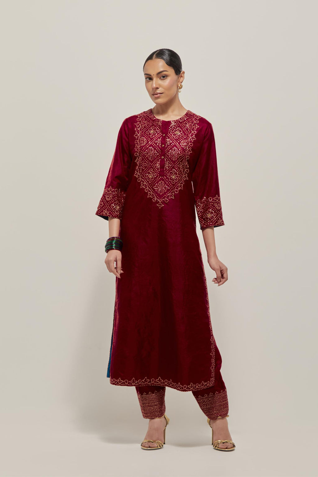Red Silk kurta set with hand embroidered sequins on bandhani inspired jaal work at neck, hem and sleeves cuff, highlighted with contrast-colored beads.