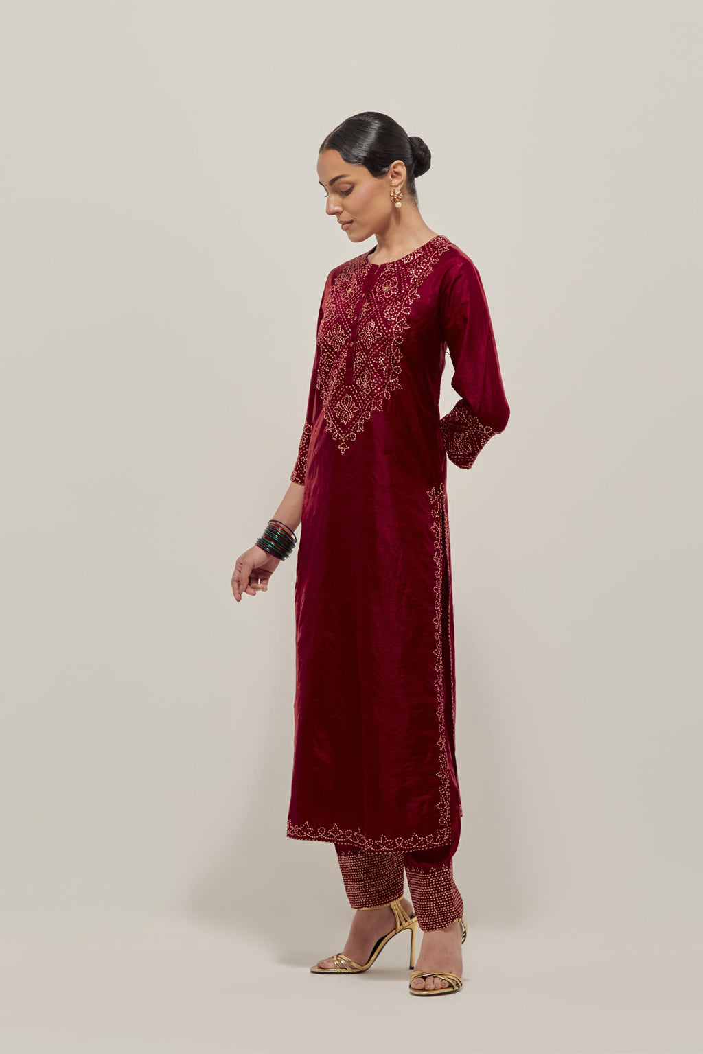 Red Silk kurta set with hand embroidered sequins on bandhani inspired jaal work at neck, hem and sleeves cuff, highlighted with contrast-colored beads.