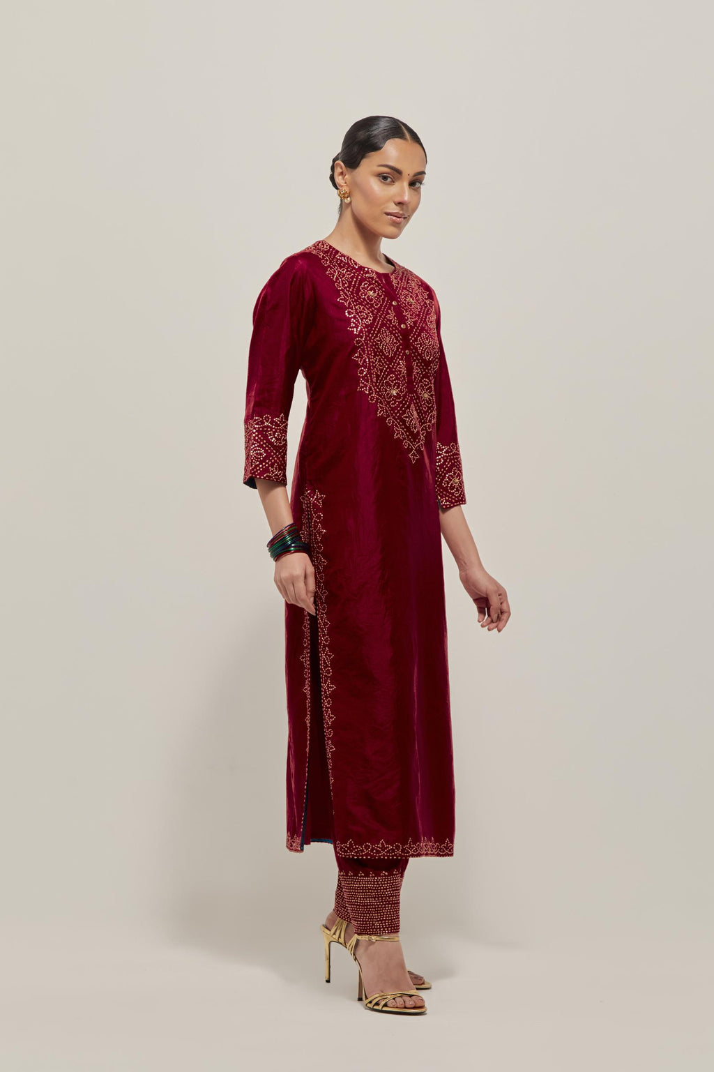 Red Silk kurta set with hand embroidered sequins on bandhani inspired jaal work at neck, hem and sleeves cuff, highlighted with contrast-colored beads.