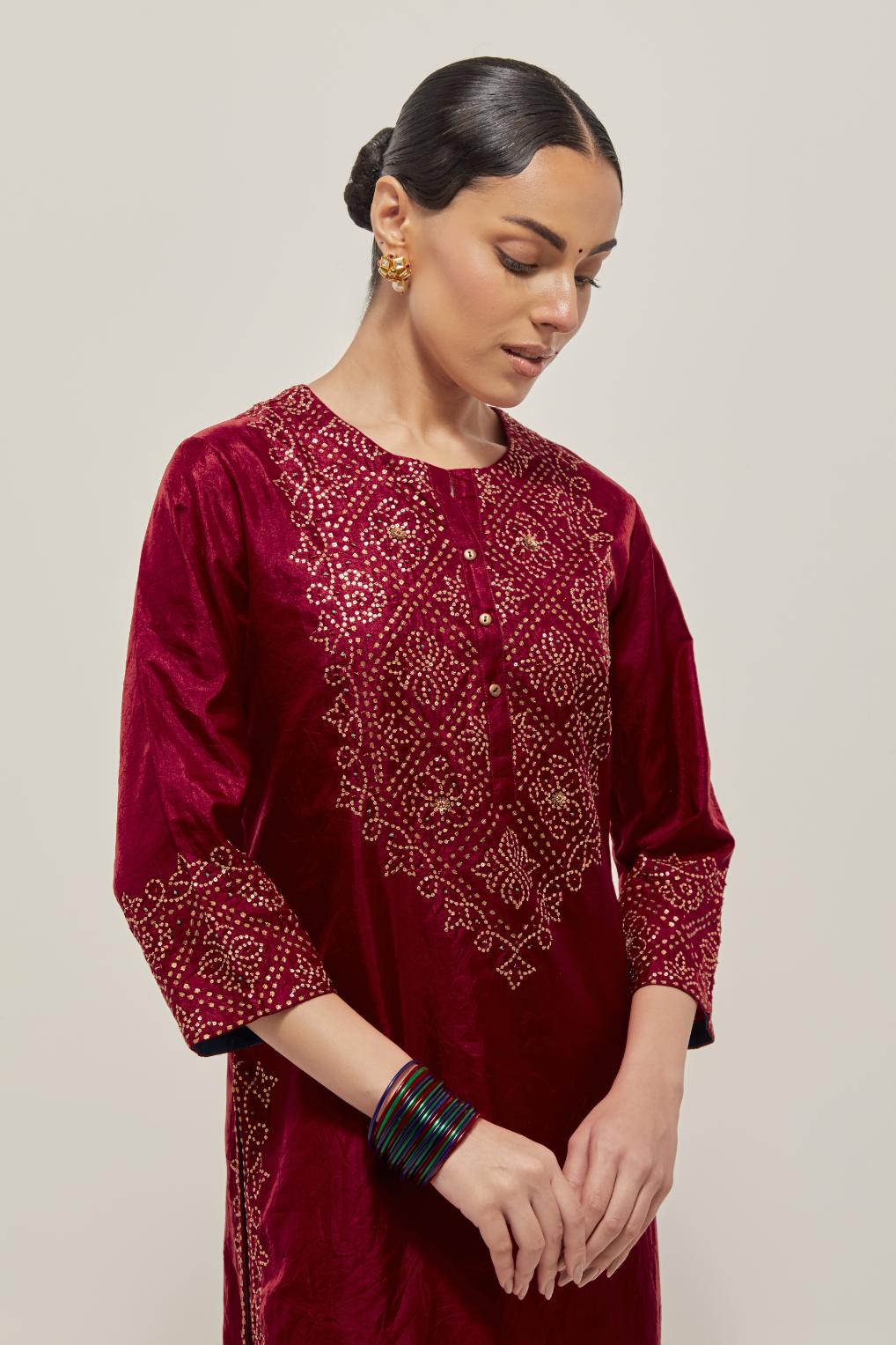 Red Silk kurta set with hand embroidered sequins on bandhani inspired jaal work at neck, hem and sleeves cuff, highlighted with contrast-colored beads.