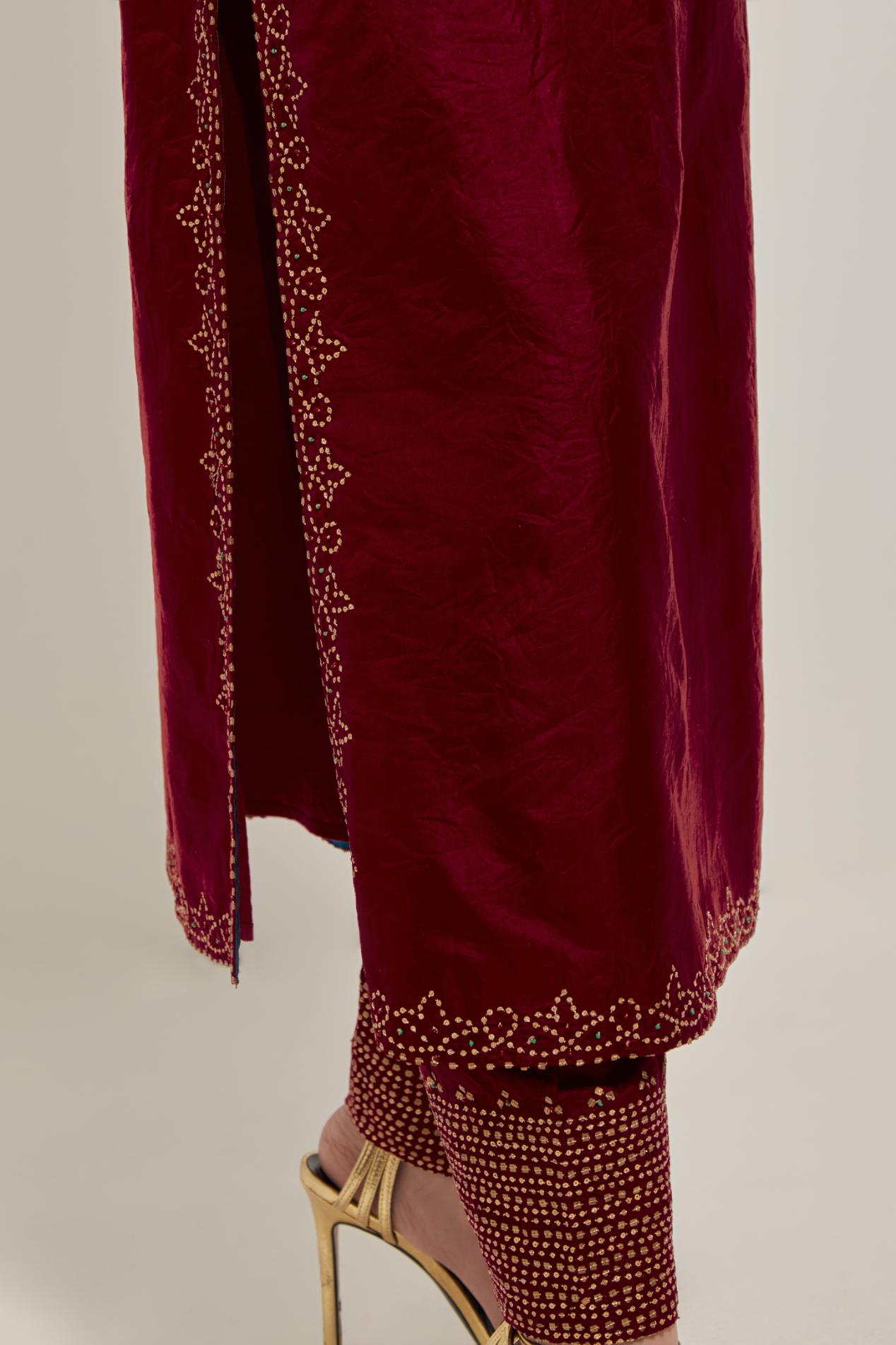 Red Silk kurta set with hand embroidered sequins on bandhani inspired jaal work at neck, hem and sleeves cuff, highlighted with contrast-colored beads.