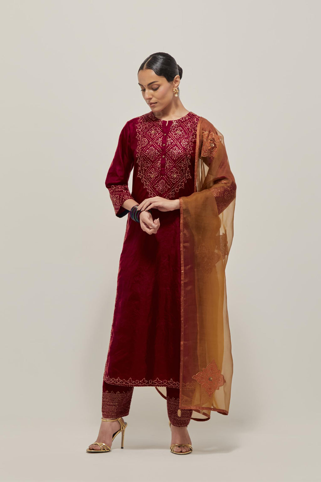 Red Silk kurta set with hand embroidered sequins on bandhani inspired jaal work at neck, hem and sleeves cuff, highlighted with contrast-colored beads.