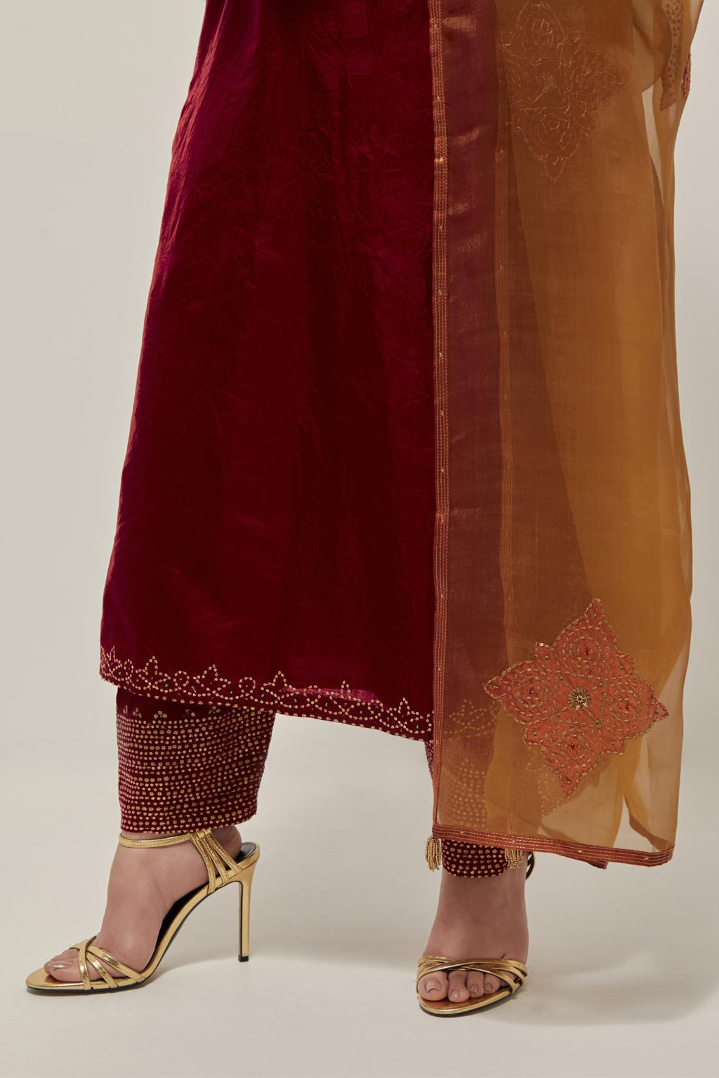 Red Silk kurta set with hand embroidered sequins on bandhani inspired jaal work at neck, hem and sleeves cuff, highlighted with contrast-colored beads.