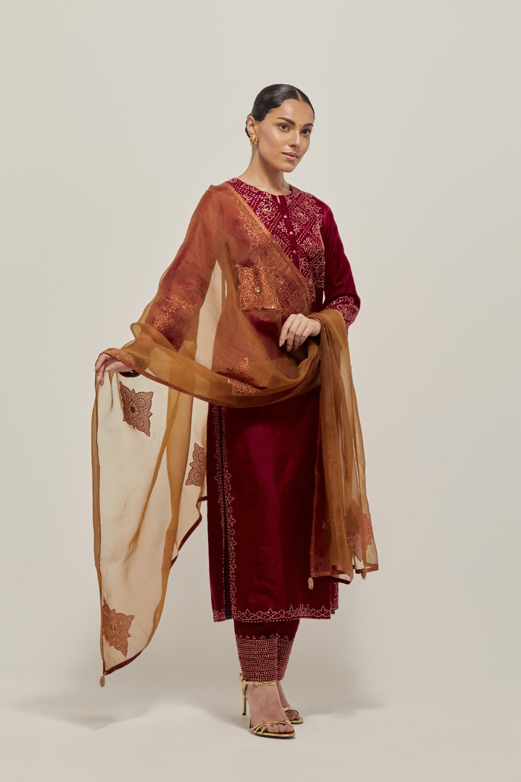 Red Silk kurta set with hand embroidered sequins on bandhani inspired jaal work at neck, hem and sleeves cuff, highlighted with contrast-colored beads.