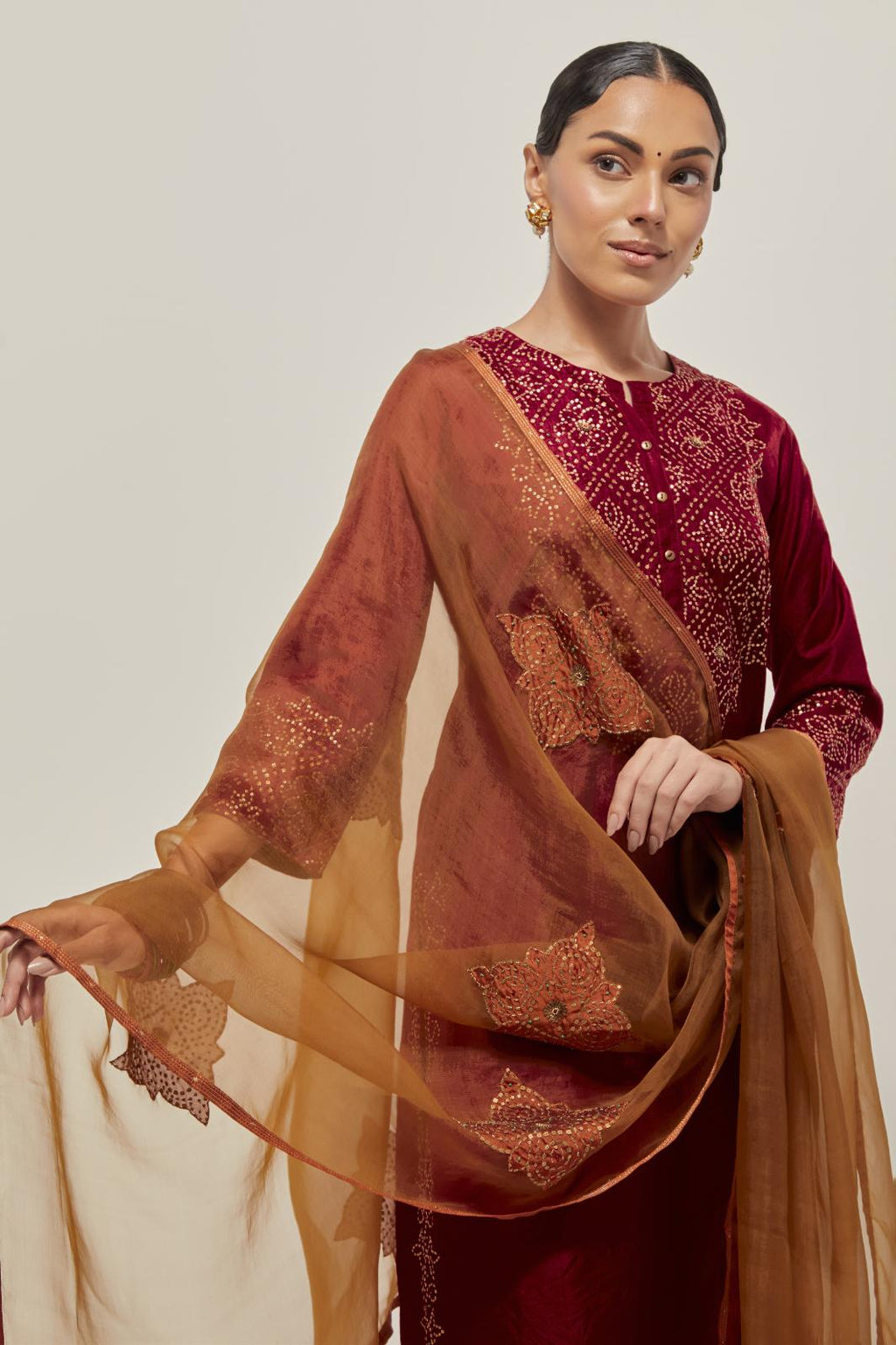 Red Silk kurta set with hand embroidered sequins on bandhani inspired jaal work at neck, hem and sleeves cuff, highlighted with contrast-colored beads.