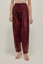 Maroon Silk salwar, highlighted with hand embroidered bead, sequins and zardozi boota at hem, highlighted with contrast bead work.