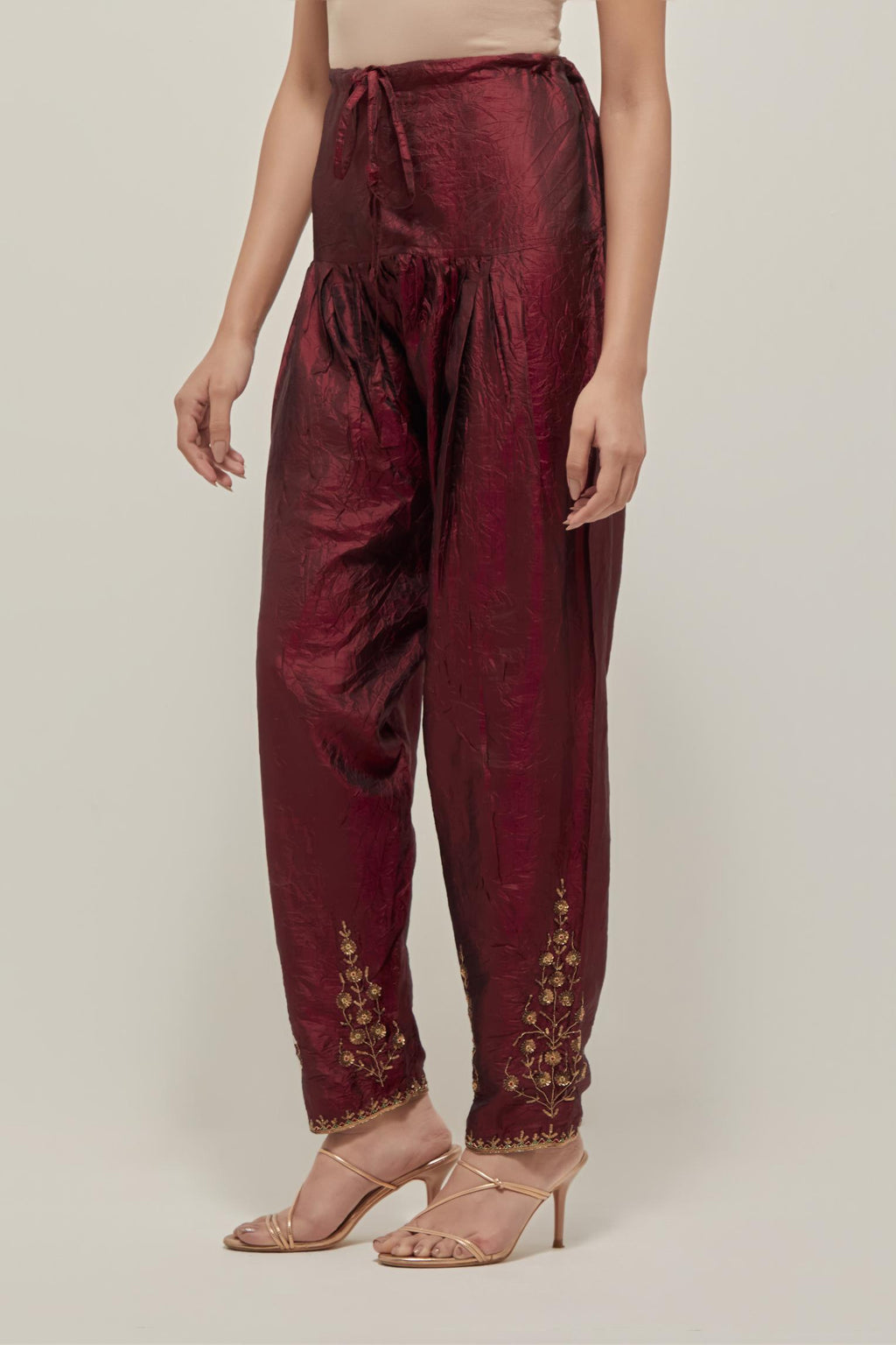 Maroon Silk salwar, highlighted with hand embroidered bead, sequins and zardozi boota at hem, highlighted with contrast bead work.