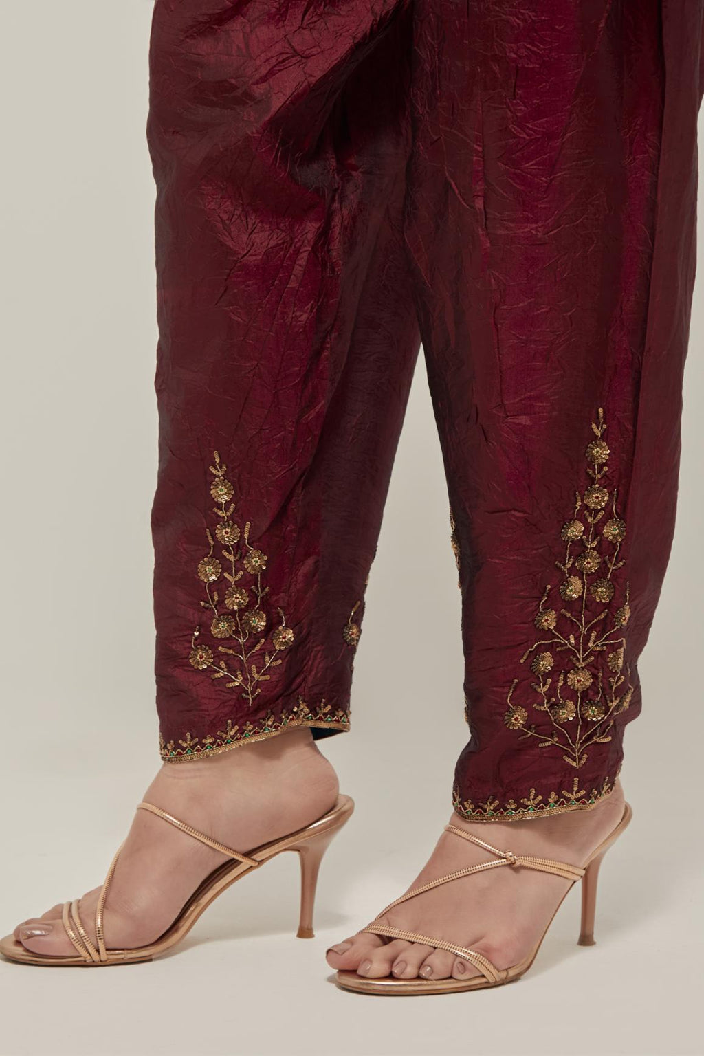 Maroon Silk salwar, highlighted with hand embroidered bead, sequins and zardozi boota at hem, highlighted with contrast bead work.