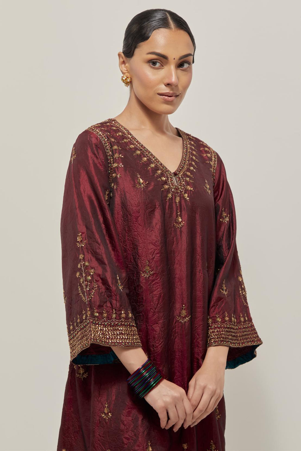 Maroon double toned silk easy fit short kurta set with hand embroidered zardozi and sequins, highlighted with beads.