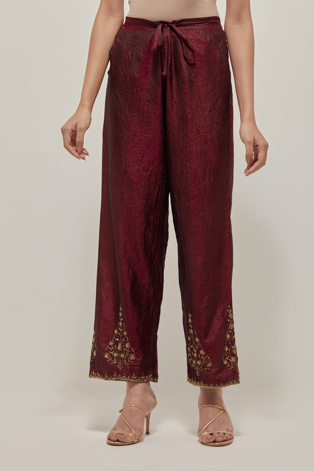 Maroon Silk pants, highlighted with hand embroidered bead, sequins and zardozi boota at hem, highlighted with contrast bead work.