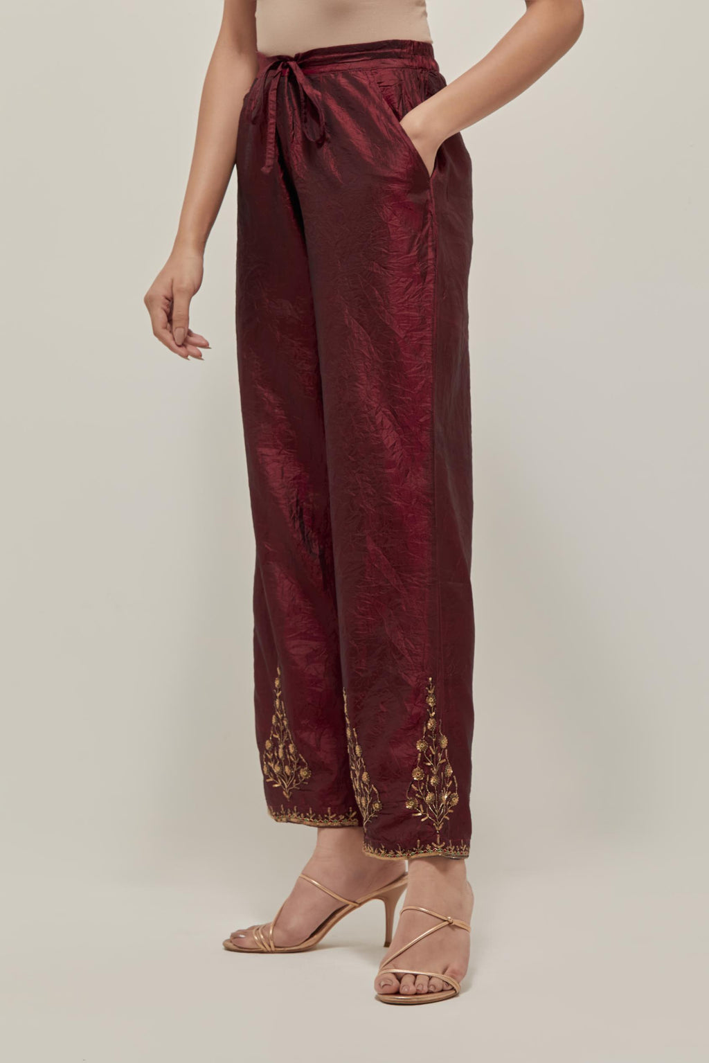 Maroon Silk pants, highlighted with hand embroidered bead, sequins and zardozi boota at hem, highlighted with contrast bead work.