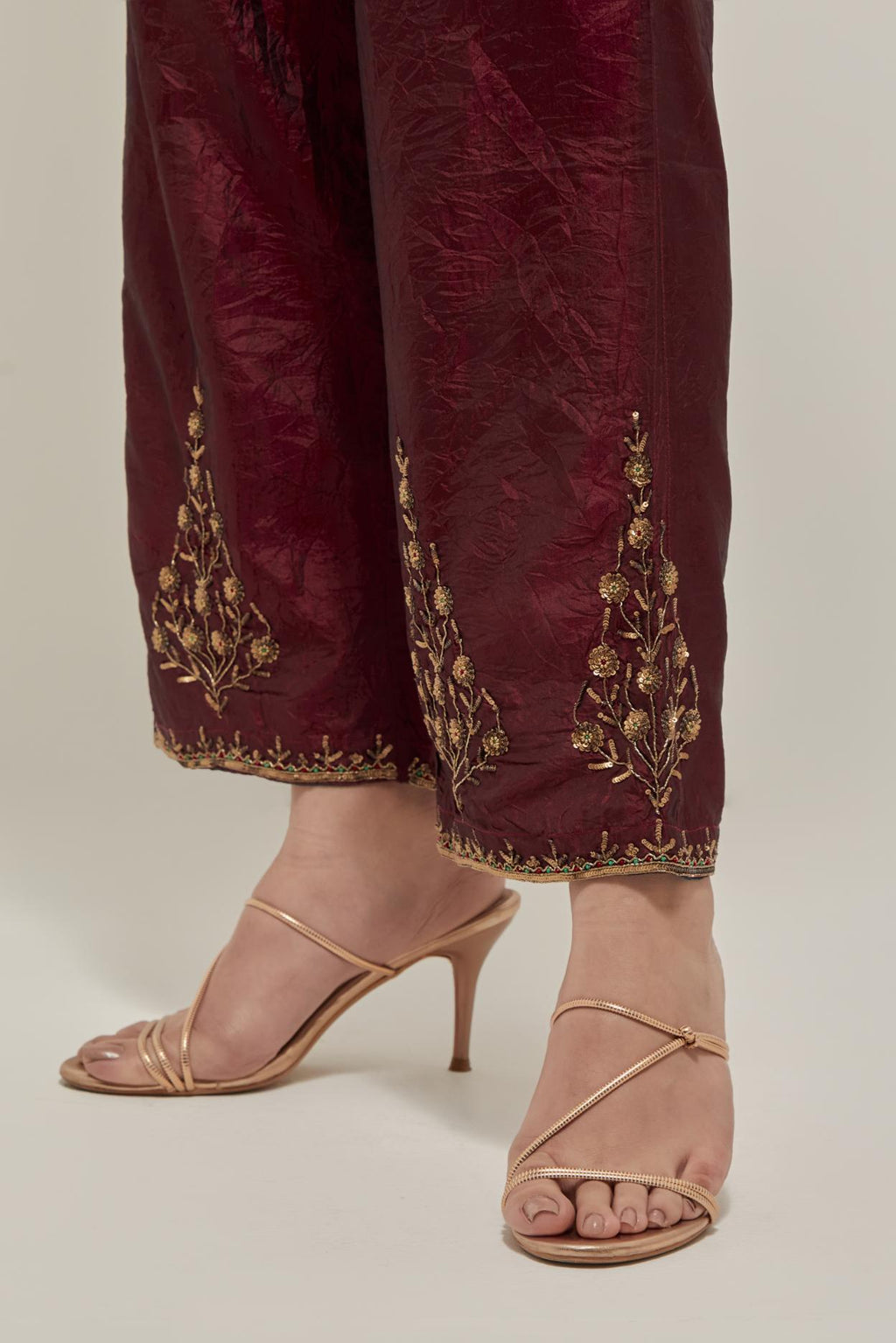 Maroon Silk pants, highlighted with hand embroidered bead, sequins and zardozi boota at hem, highlighted with contrast bead work.