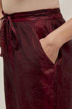 Maroon Silk pants, highlighted with hand embroidered bead, sequins and zardozi boota at hem, highlighted with contrast bead work.