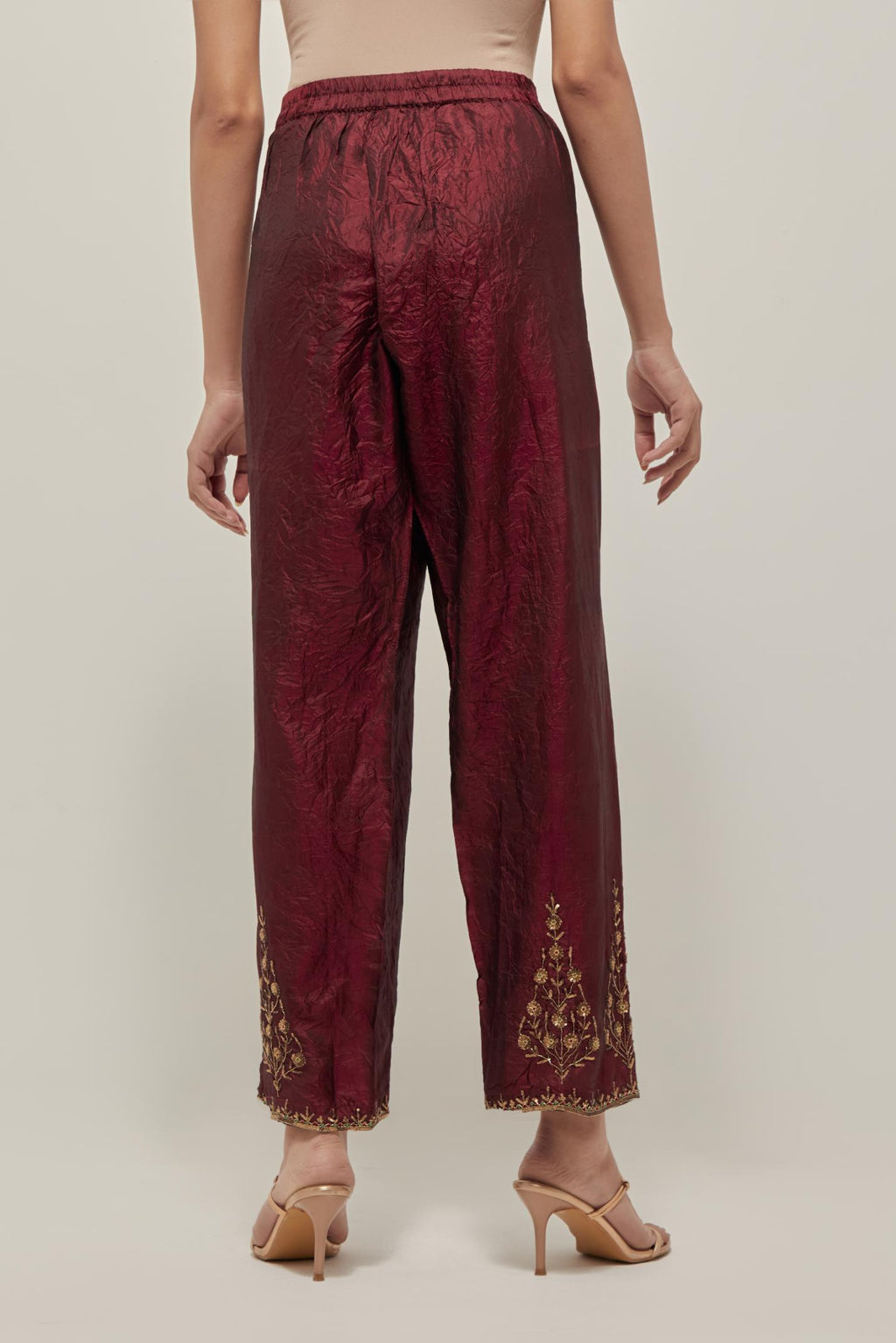 Maroon Silk pants, highlighted with hand embroidered bead, sequins and zardozi boota at hem, highlighted with contrast bead work.