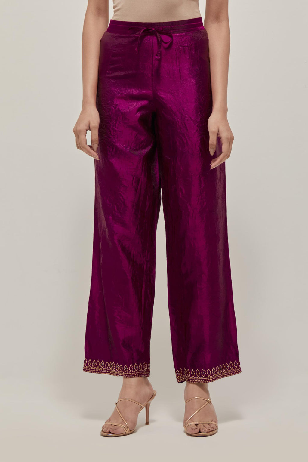 Wine silk pants with a narrow bandhani-inspired border at the hem, detailed with delicate bead and sequin work.