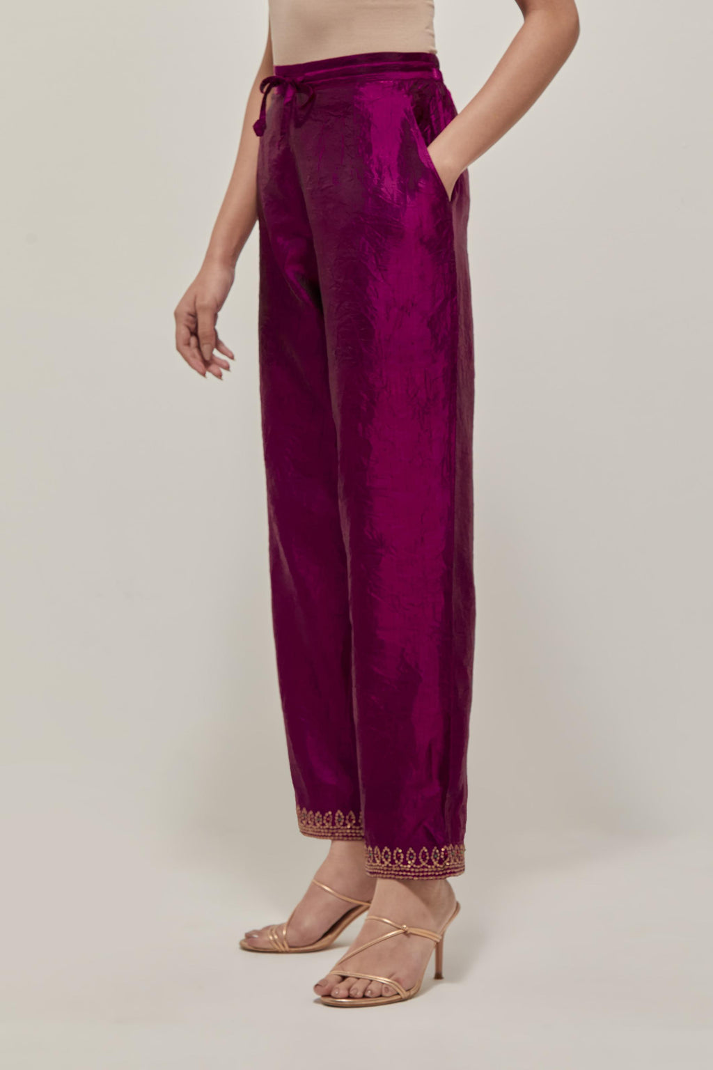 Wine silk pants with a narrow bandhani-inspired border at the hem, detailed with delicate bead and sequin work.