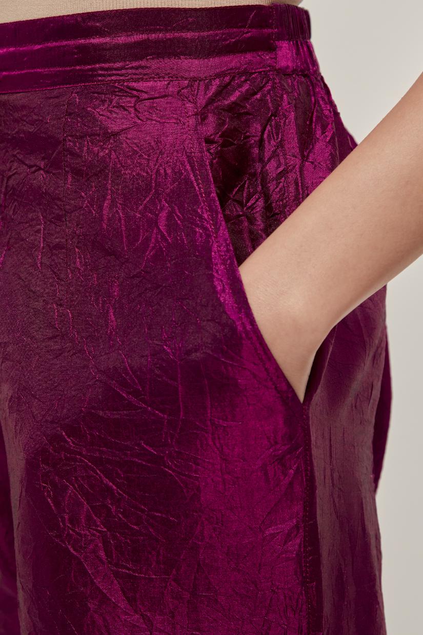 Wine silk pants with a narrow bandhani-inspired border at the hem, detailed with delicate bead and sequin work.