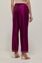 Wine silk pants with a narrow bandhani-inspired border at the hem, detailed with delicate bead and sequin work.