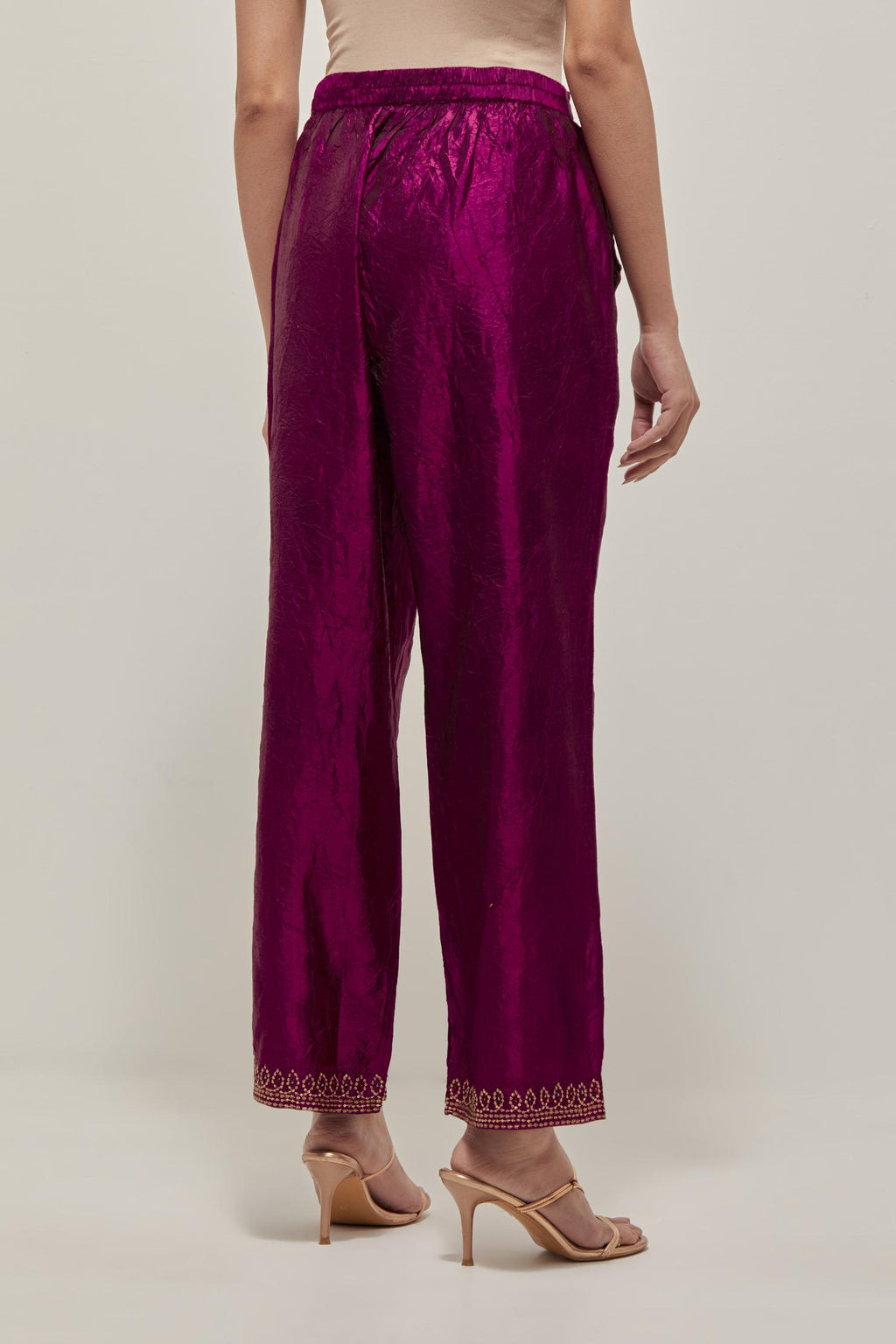 Wine silk pants with a narrow bandhani-inspired border at the hem, detailed with delicate bead and sequin work.