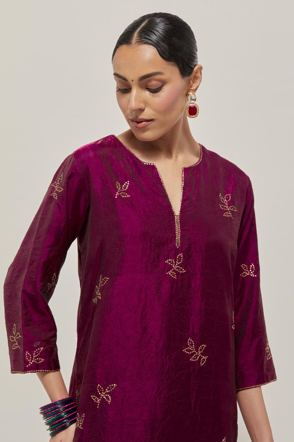 Wine Silk kurta set with hand embroidered sequins on bandhani inspired floral motif all-over the kurta, highlighted with contrast-colored beads.