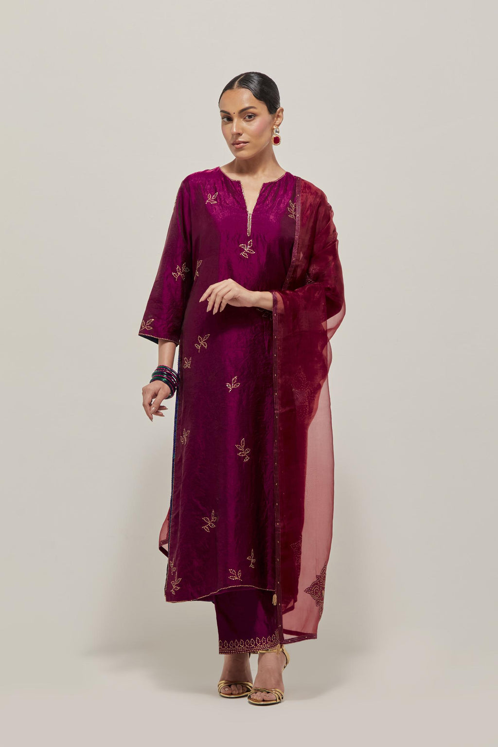 Wine Silk kurta set with hand embroidered sequins on bandhani inspired floral motif all-over the kurta, highlighted with contrast-colored beads.