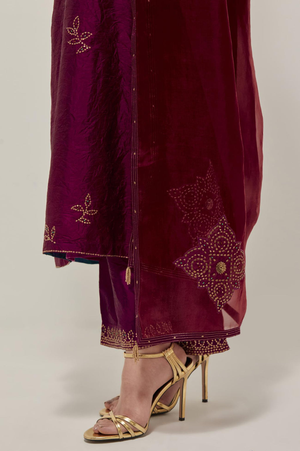 Wine Silk kurta set with hand embroidered sequins on bandhani inspired floral motif all-over the kurta, highlighted with contrast-colored beads.