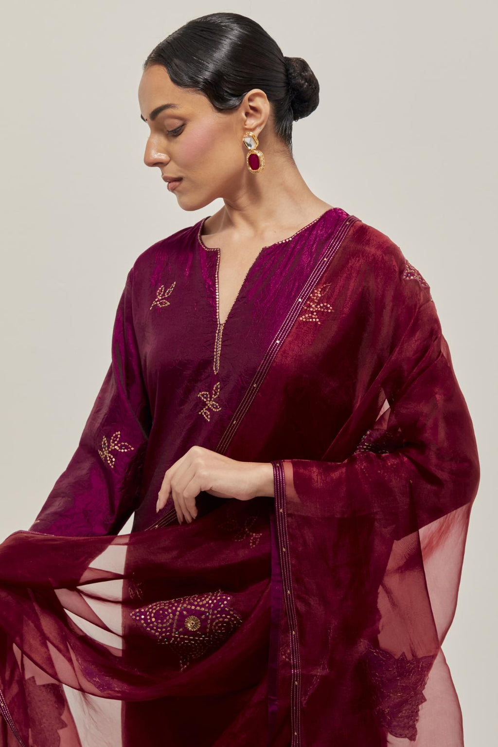 Wine Silk kurta set with hand embroidered sequins on bandhani inspired floral motif all-over the kurta, highlighted with contrast-colored beads.