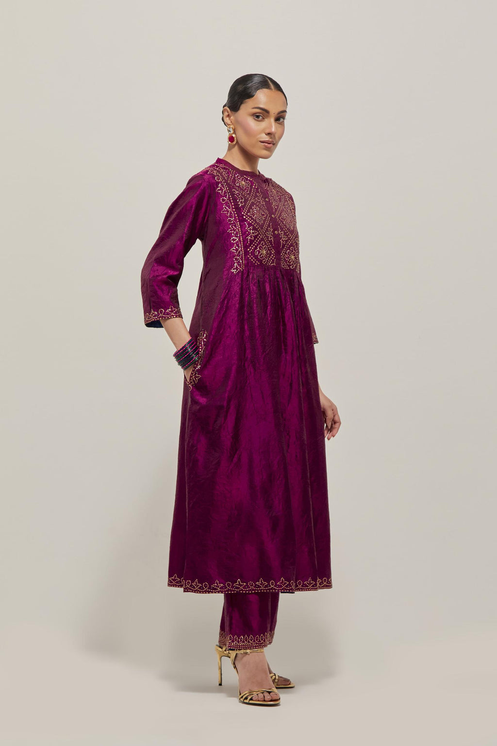 Purple Silk kurta dress set  with hand embroidered sequins on bandhani inspired jaal work at neck, hem and sleeves cuff, highlighted with contrast-colored beads.