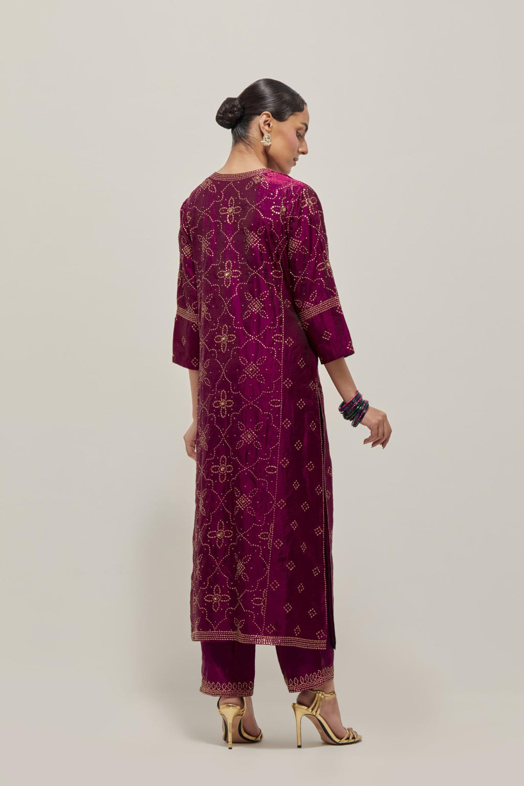 Wine Silk kurta set with all-over hand embroidered sequins on bandhani inspired floral jaal and small square booti at side panels, highlighted with contrast-colored beads.