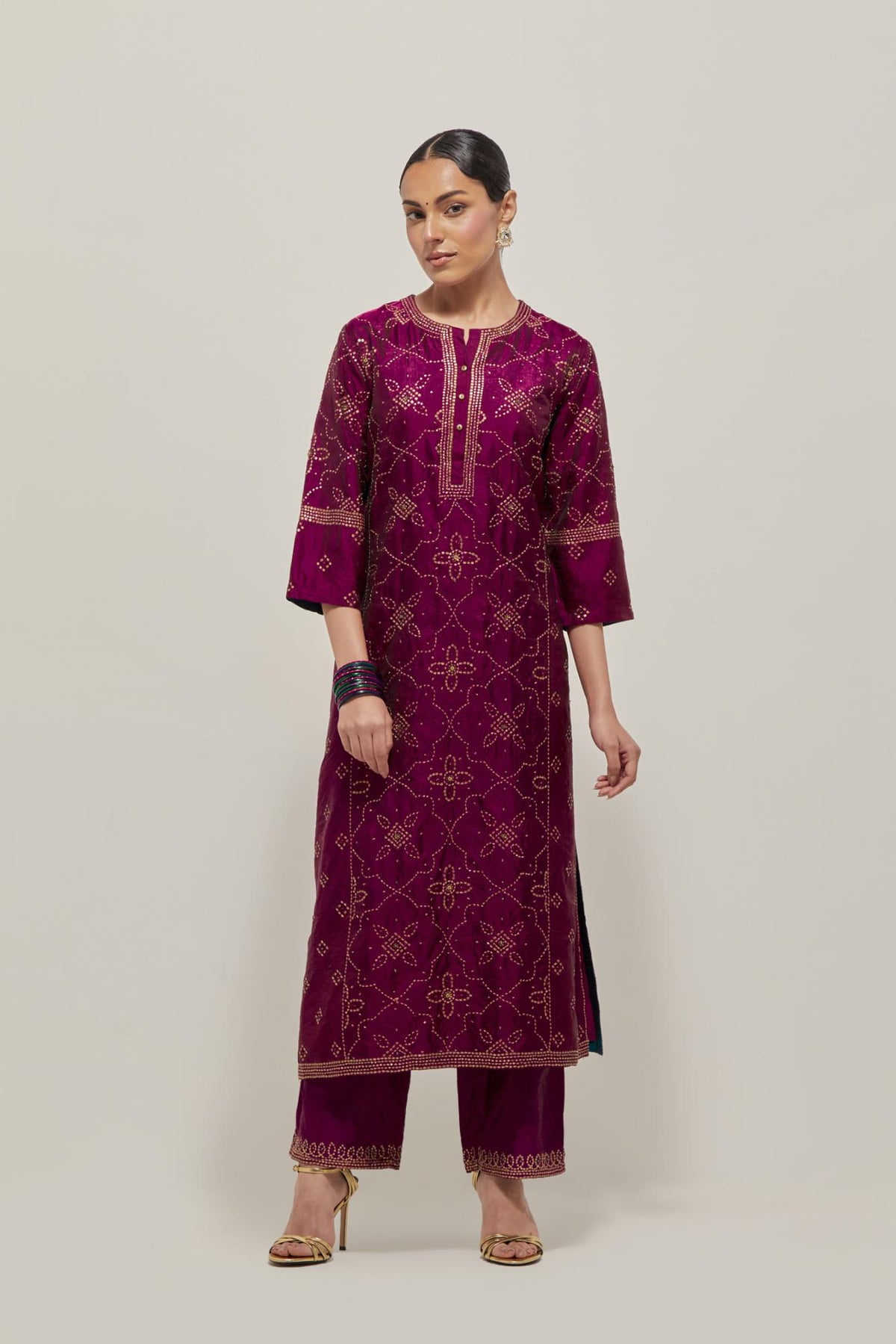 Wine Silk kurta set with all-over hand embroidered sequins on bandhani inspired floral jaal and small square booti at side panels, highlighted with contrast-colored beads.