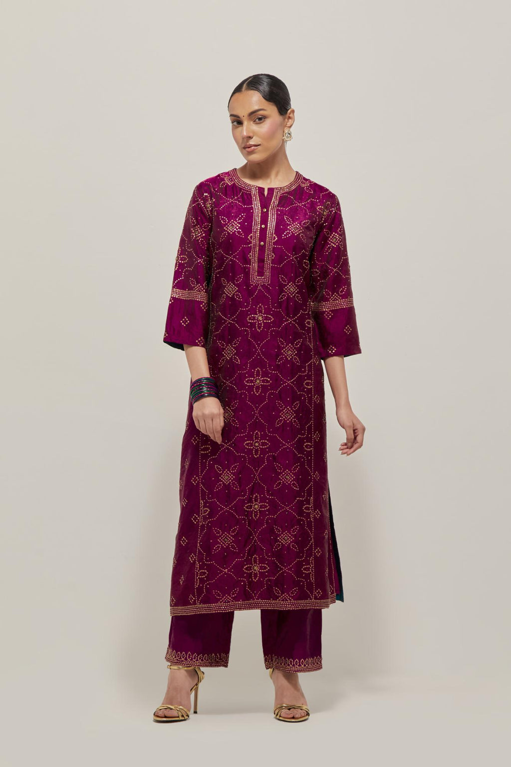 Wine Silk kurta set with all-over hand embroidered sequins on bandhani inspired floral jaal and small square booti at side panels, highlighted with contrast-colored beads.