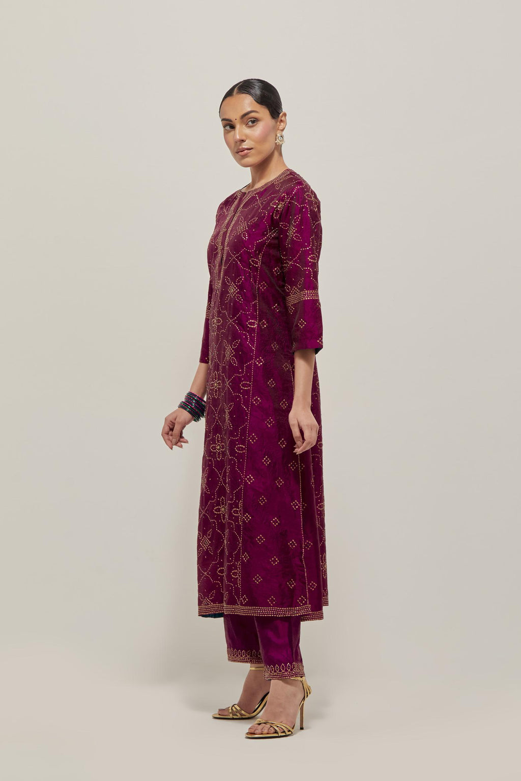 Wine Silk kurta set with all-over hand embroidered sequins on bandhani inspired floral jaal and small square booti at side panels, highlighted with contrast-colored beads.
