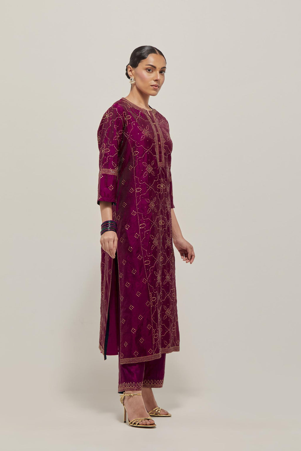 Wine Silk kurta set with all-over hand embroidered sequins on bandhani inspired floral jaal and small square booti at side panels, highlighted with contrast-colored beads.