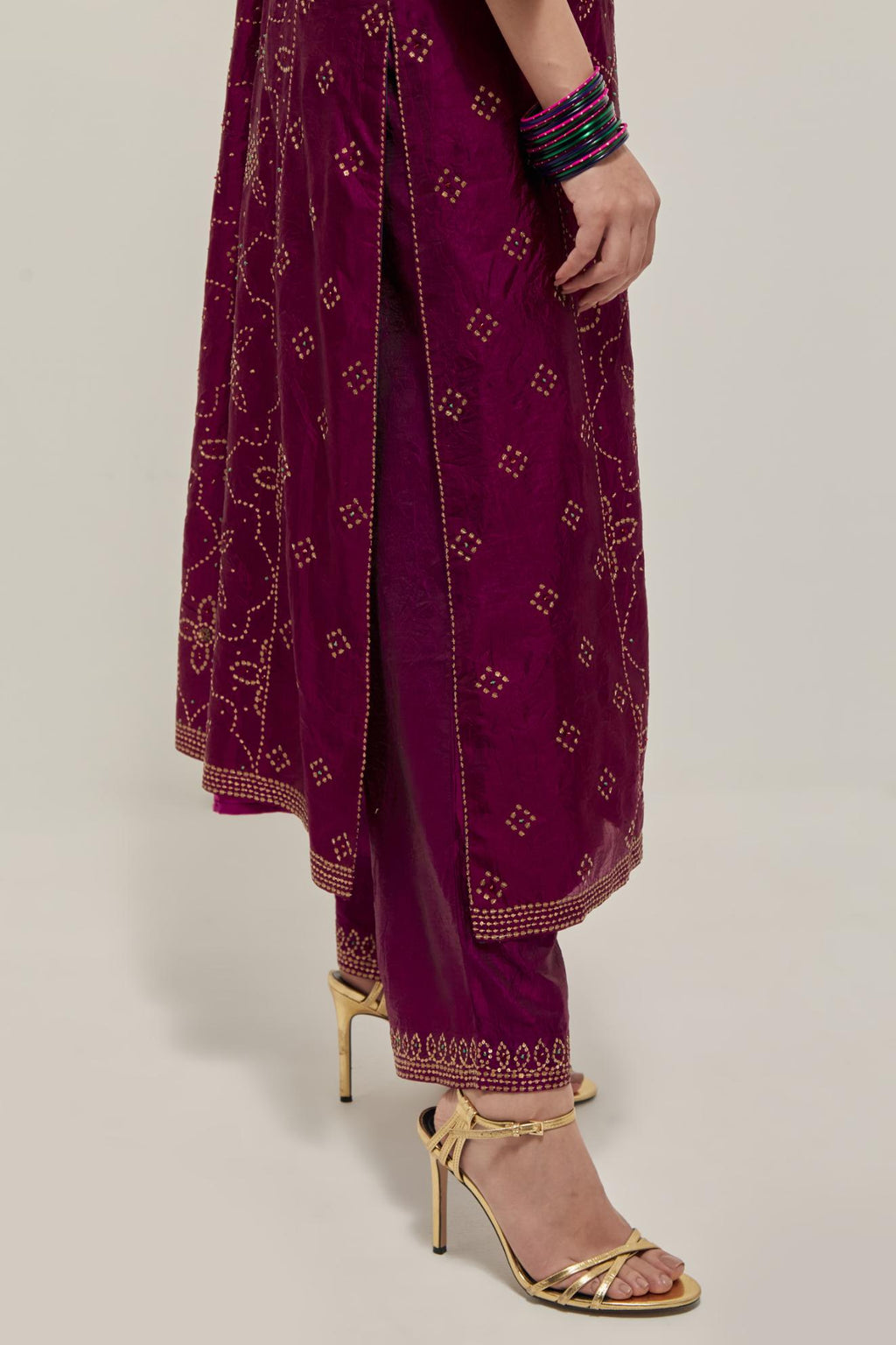 Wine Silk kurta set with all-over hand embroidered sequins on bandhani inspired floral jaal and small square booti at side panels, highlighted with contrast-colored beads.