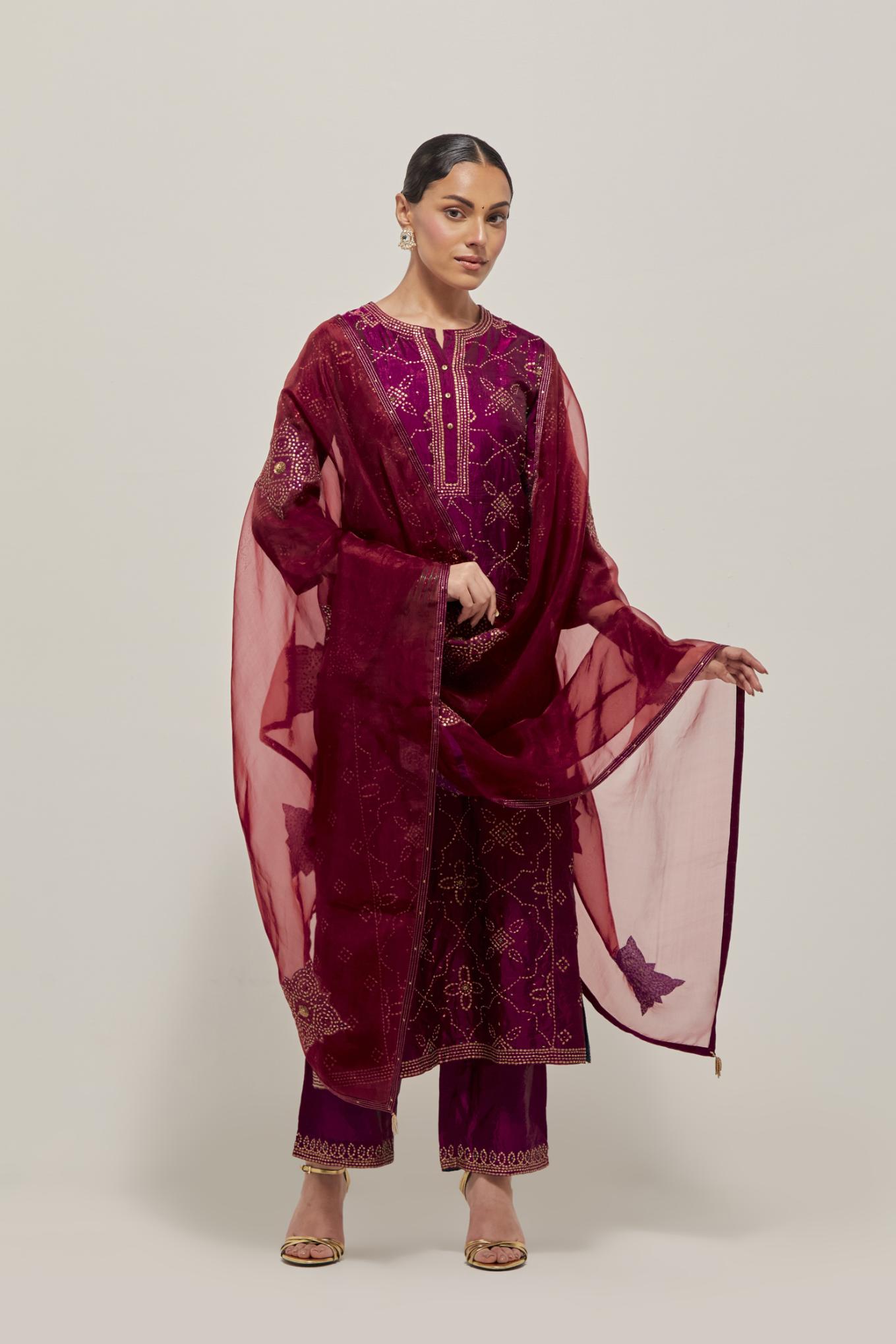 Wine Silk kurta set with all-over hand embroidered sequins on bandhani inspired floral jaal and small square booti at side panels, highlighted with contrast-colored beads.