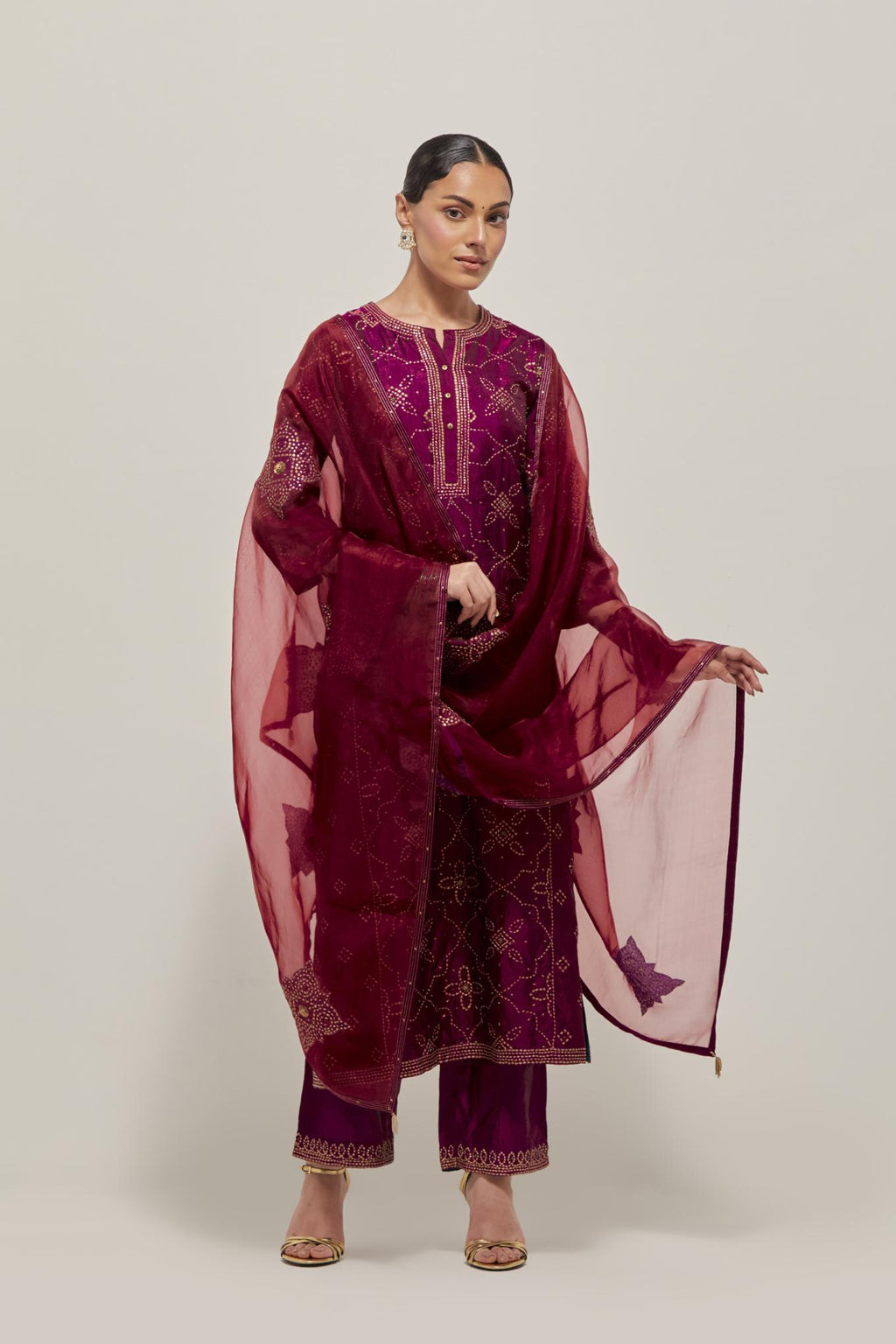 Wine Silk kurta set with all-over hand embroidered sequins on bandhani inspired floral jaal and small square booti at side panels, highlighted with contrast-colored beads.