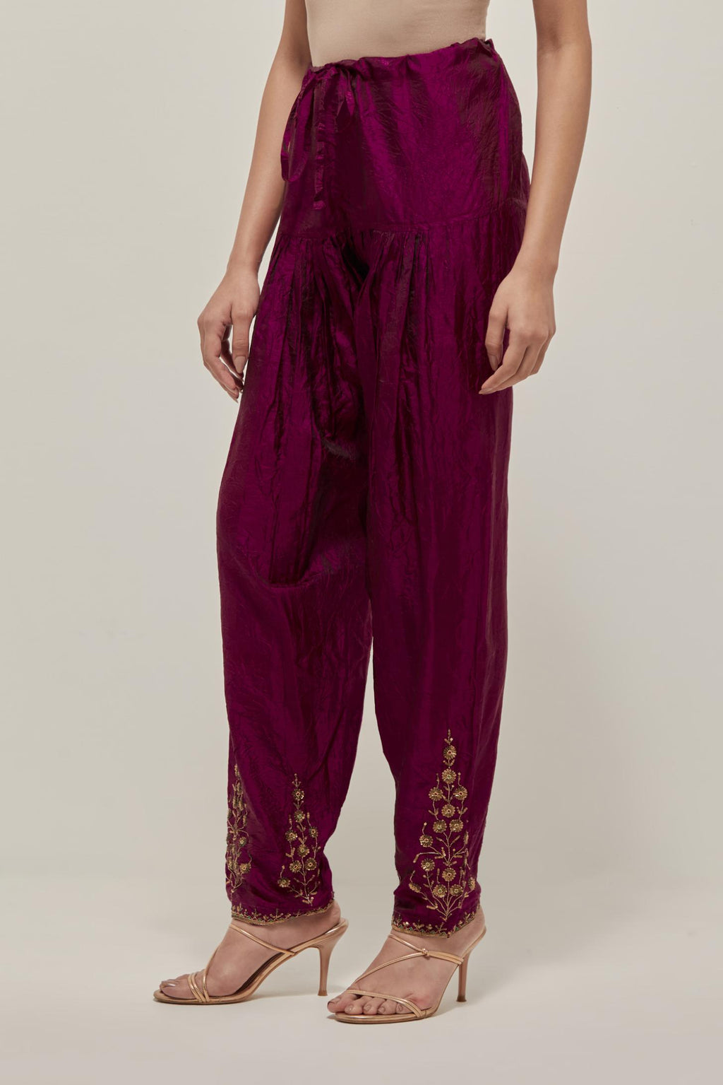 Wine Silk salwar, highlighted with hand embroidered bead, sequins and zardozi boota at hem, highlighted with contrast bead work.