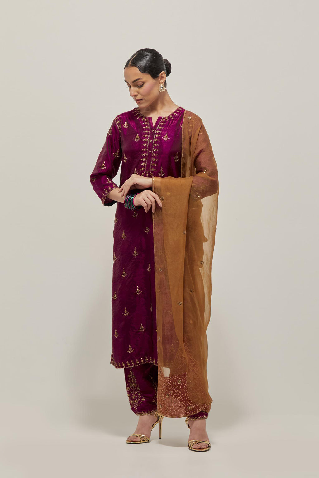 Wine double toned silk straight kurta with all-over hand embroidered zardozi and sequins work, highlighted with beads.
