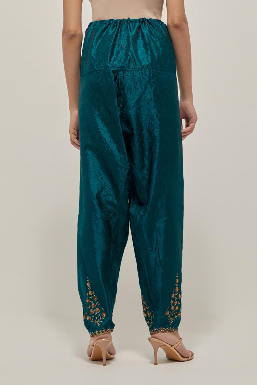 Teal Green Silk salwar, highlighted with hand embroidered bead, sequins and zardozi boota at hem, highlighted with contrast bead work.