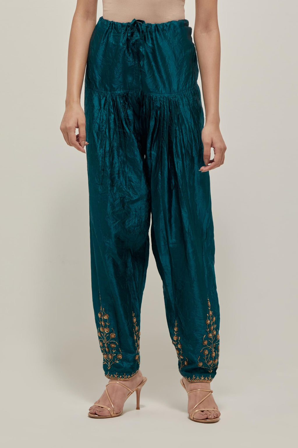 Teal Green Silk salwar, highlighted with hand embroidered bead, sequins and zardozi boota at hem, highlighted with contrast bead work.