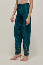 Teal Green Silk salwar, highlighted with hand embroidered bead, sequins and zardozi boota at hem, highlighted with contrast bead work.