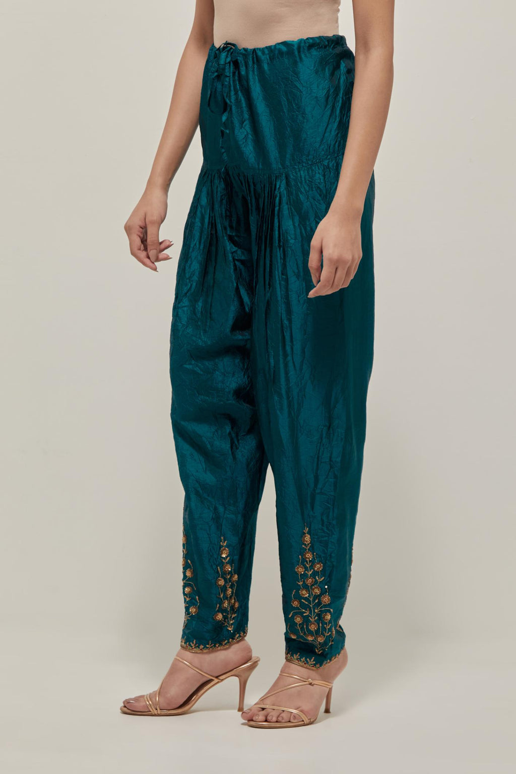 Teal Green Silk salwar, highlighted with hand embroidered bead, sequins and zardozi boota at hem, highlighted with contrast bead work.