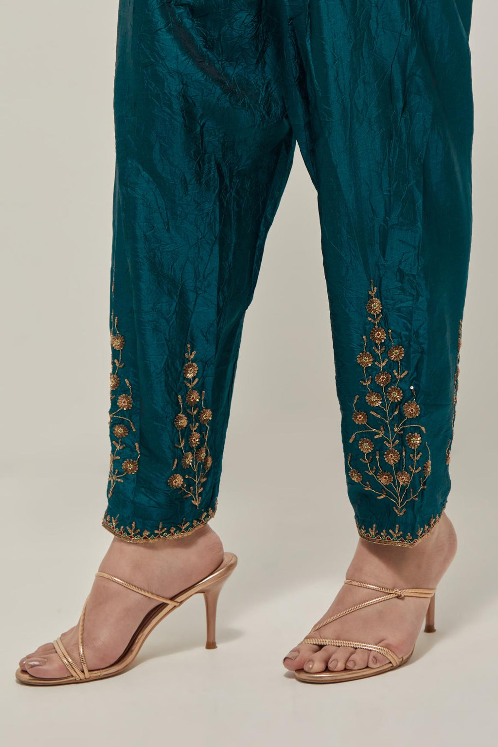 Teal Green Silk salwar, highlighted with hand embroidered bead, sequins and zardozi boota at hem, highlighted with contrast bead work.