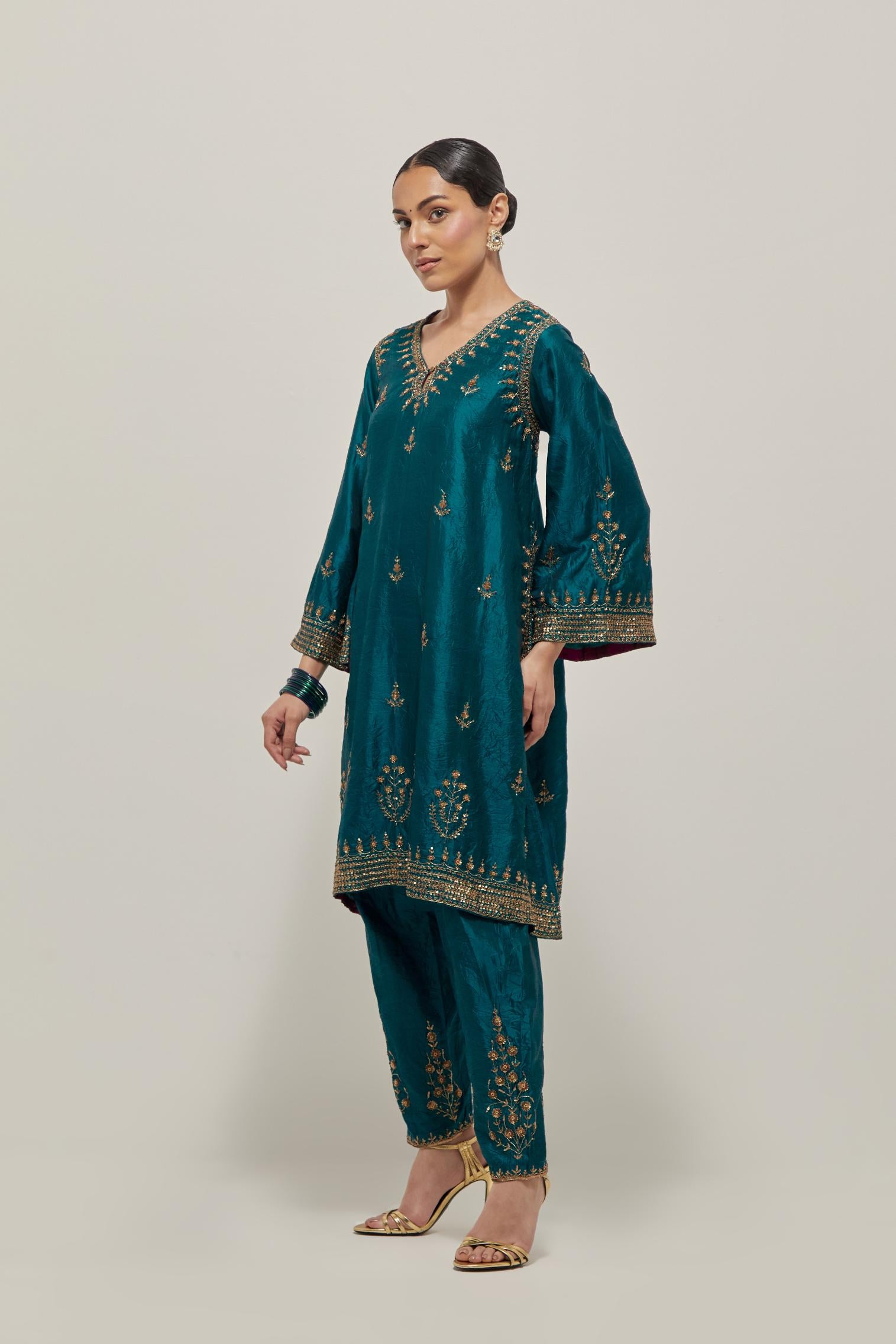 Teal Green double toned silk easy fit short kurta set with hand embroidered zardozi and sequins, highlighted with beads.